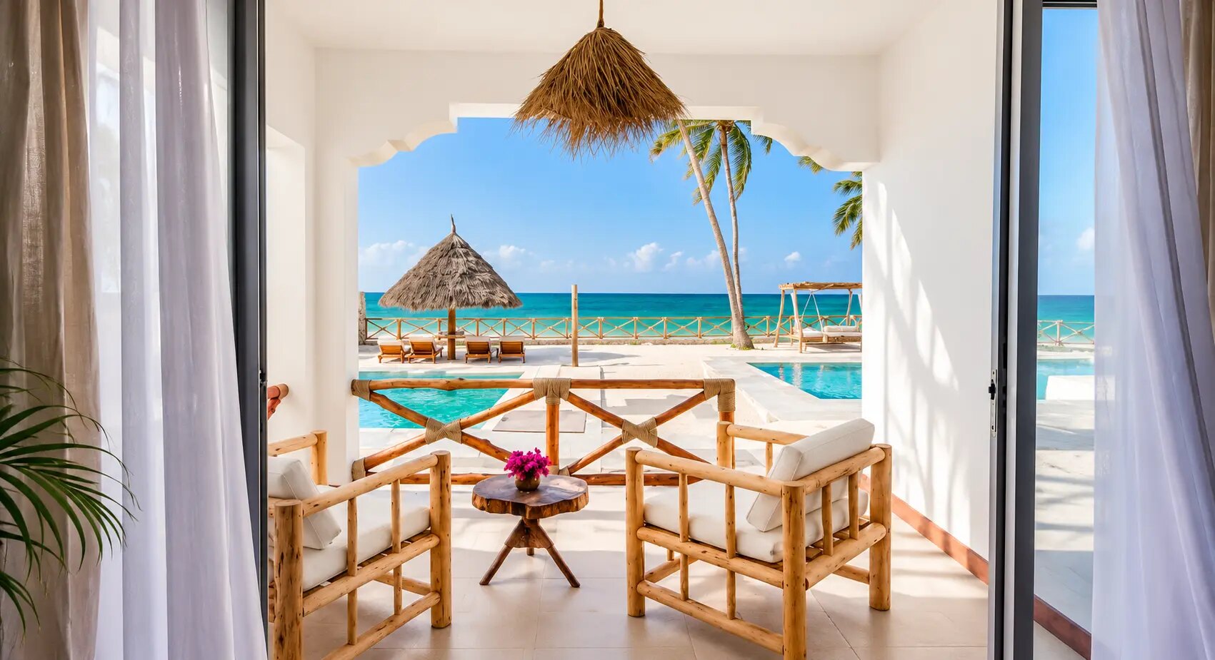 A scalloped arch framing the pool and the ocean beyond