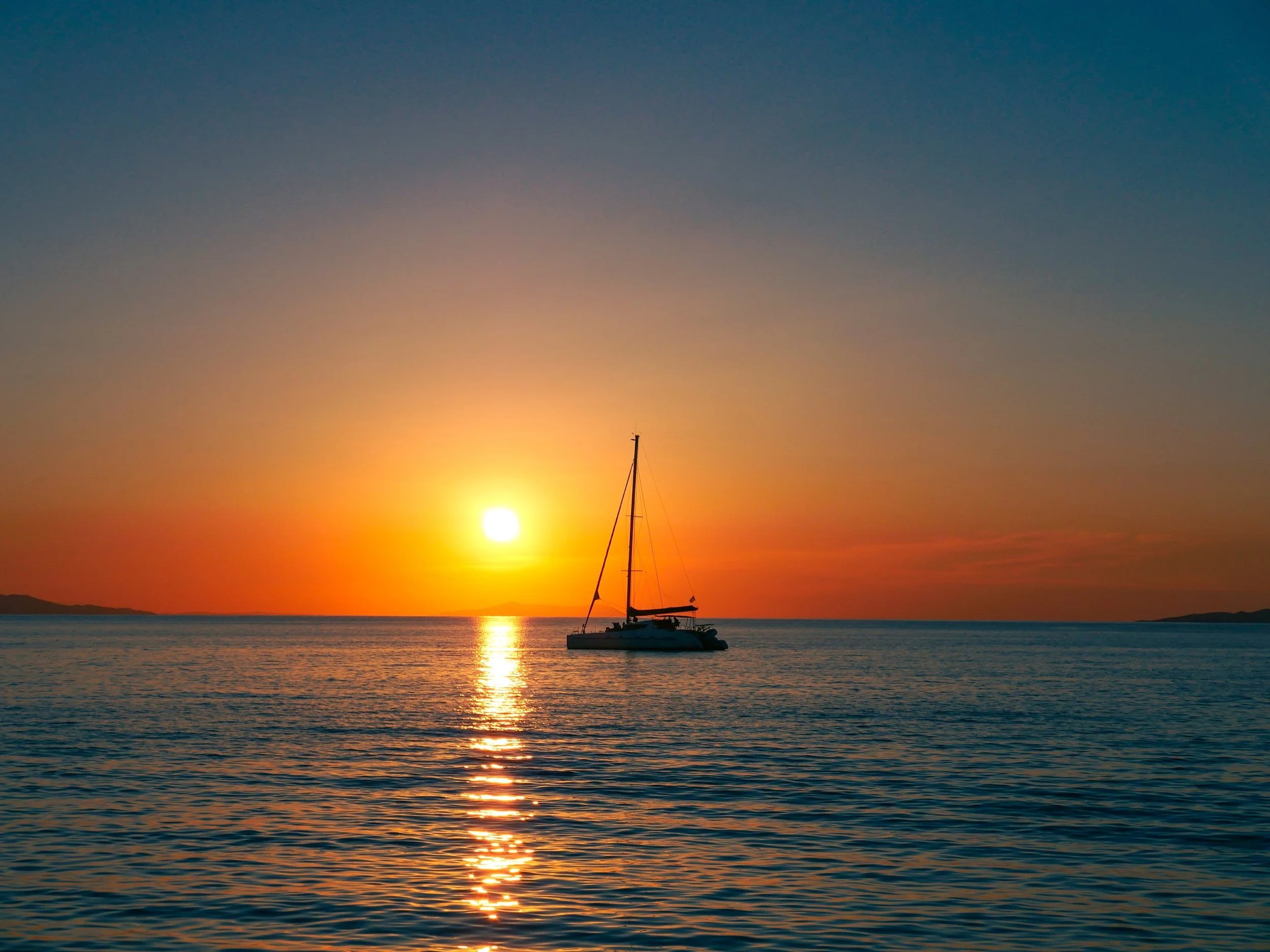 A sailing boat at sunset