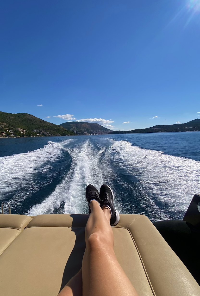 Feet up on a speedboat cutting across the sea