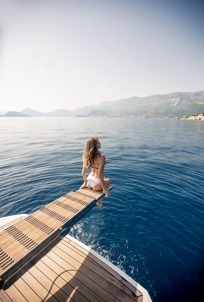 A guest at the bow of a boat on the Mediterranean