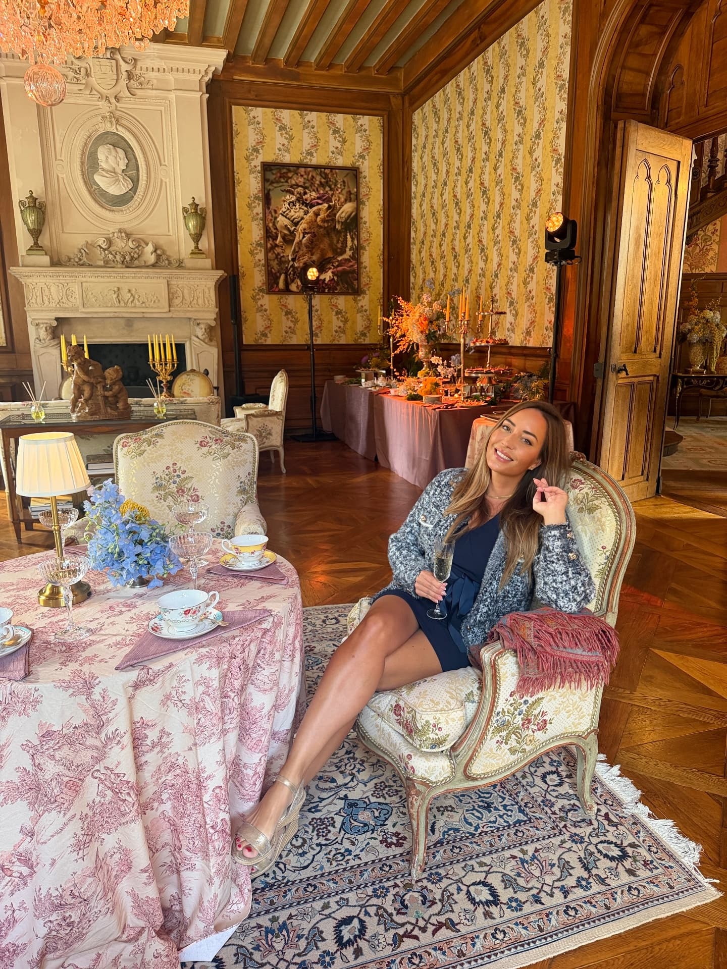 Carmen seated in an elegant French château salon